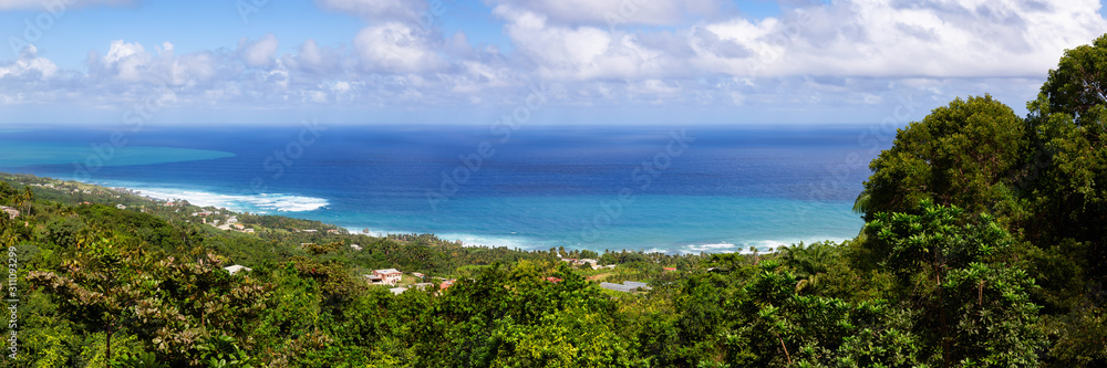 Beautiful Panoramic View of the Caribbean Sea from top of a hill during a sunny and cloudy day. Church View, Saint John, Barbados.