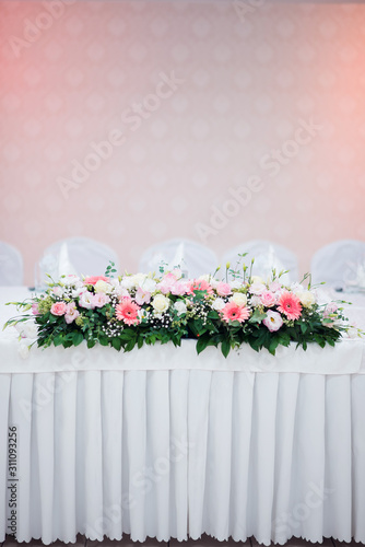 Bride and groom s wedding celebration table with flowers decoration vertical