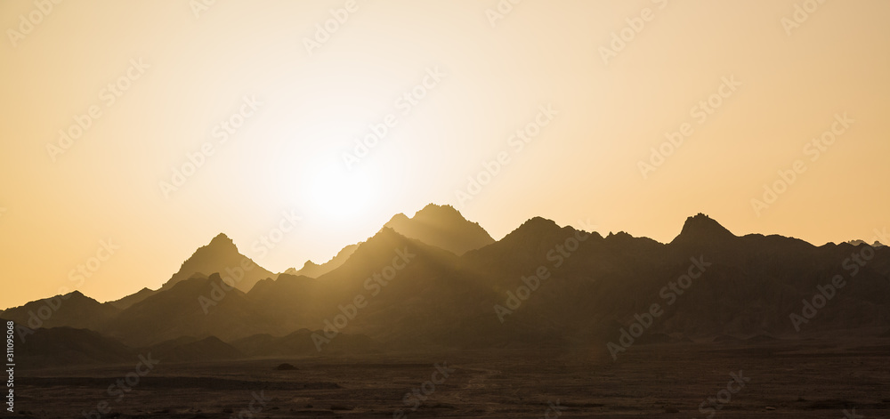sunset over desert mountain range