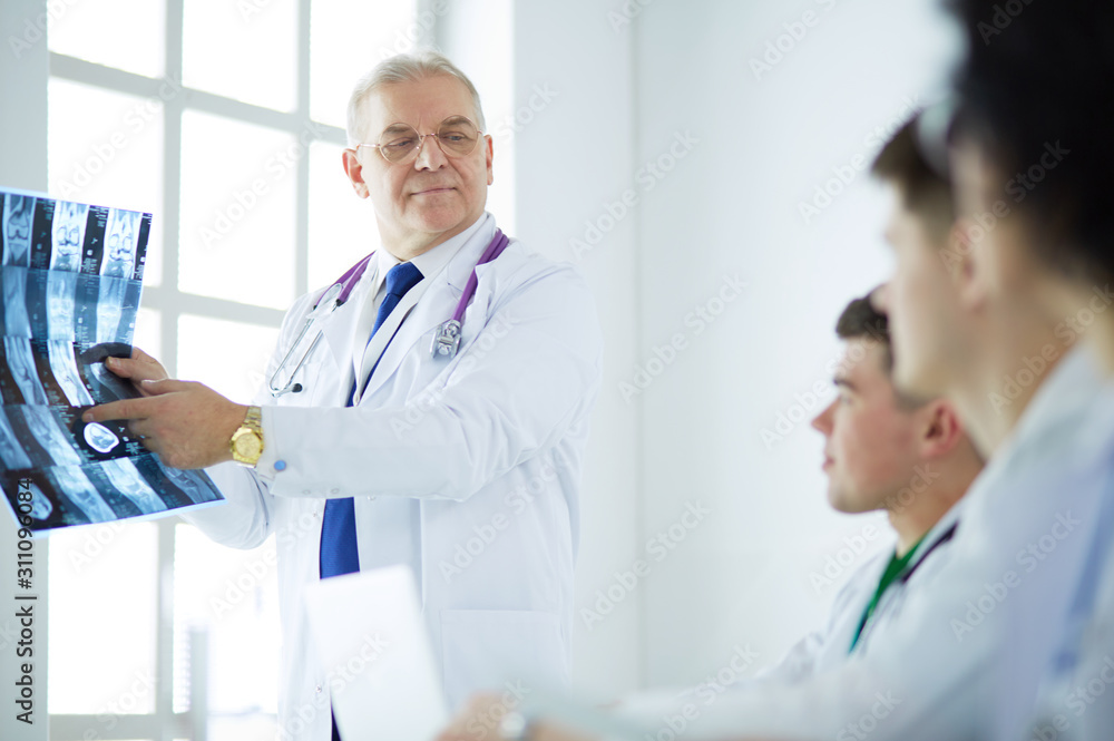 Medical team sitting and discussing at table Medical team sitting and discussing at table