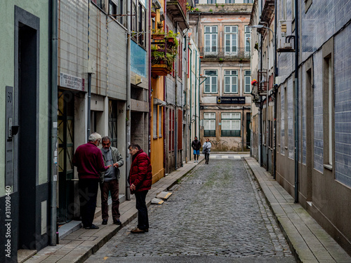 Porto, Portugal. 16 November 2019. Elderly men talking in the street.
