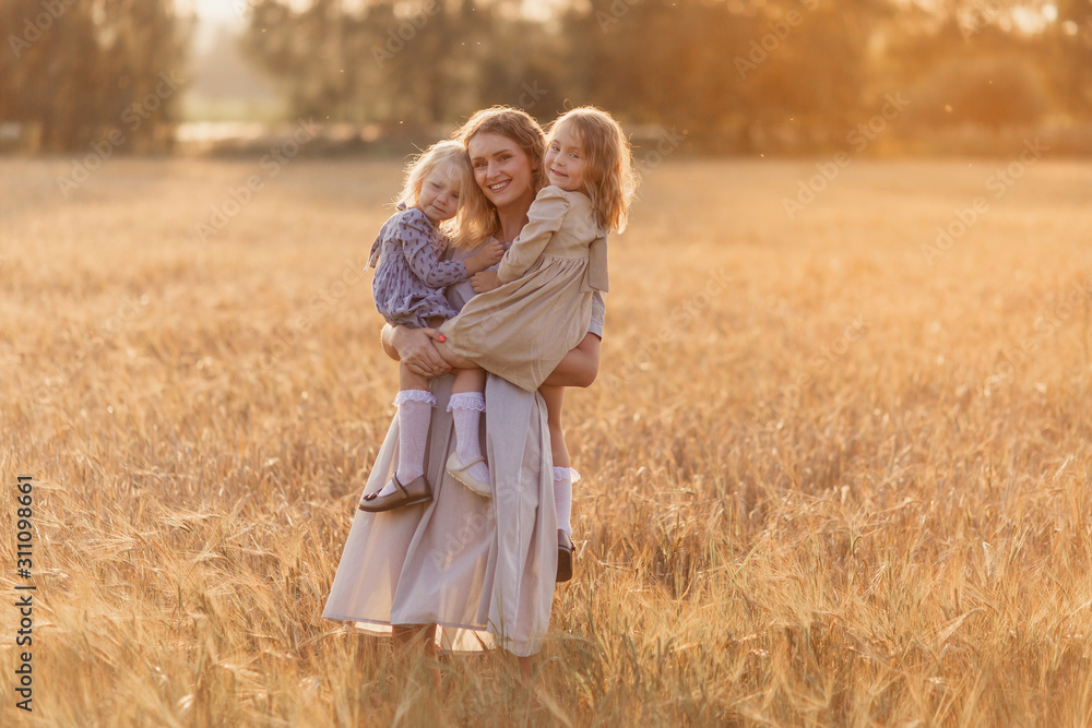 mom and two daughters look at the camera play tenderness in the field wheat natural Russia Ukraine Belarus. family motherhood childhood happiness love nature bright future children village walk mom and two daughters look at the camera play tenderness in the field wheat natural Russia Ukraine Belarus. family motherhood childhood happiness love nature bright future children village walk
