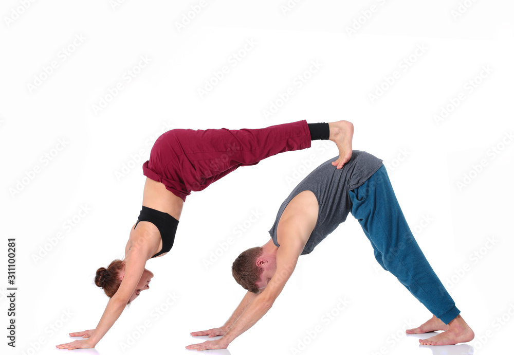 Young athletic couple practicing acroyoga. Balancing in pair. Young athletic couple practicing acroyoga. Balancing in pair.