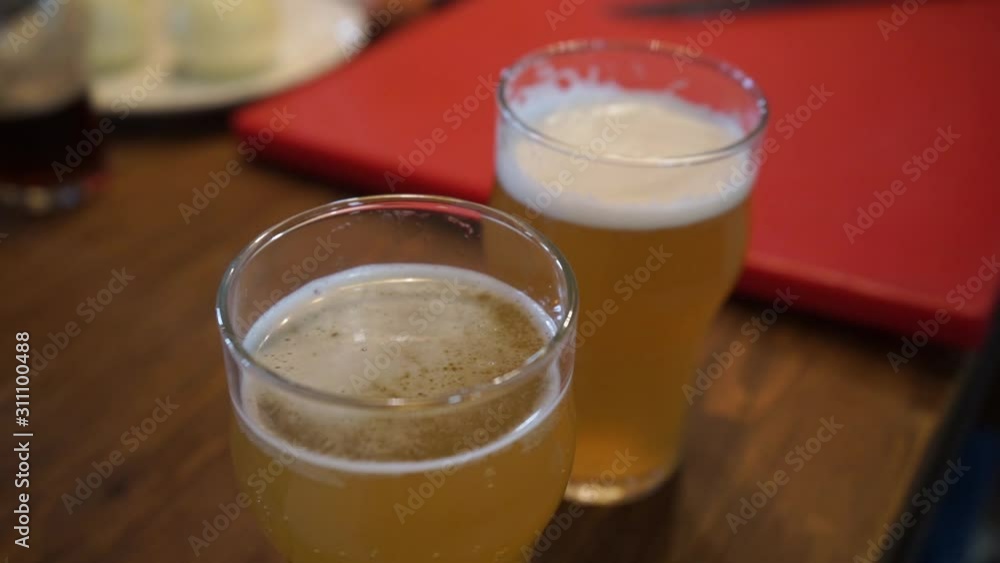 glasses with foaming aromatic beer glasses with foaming aromatic beer