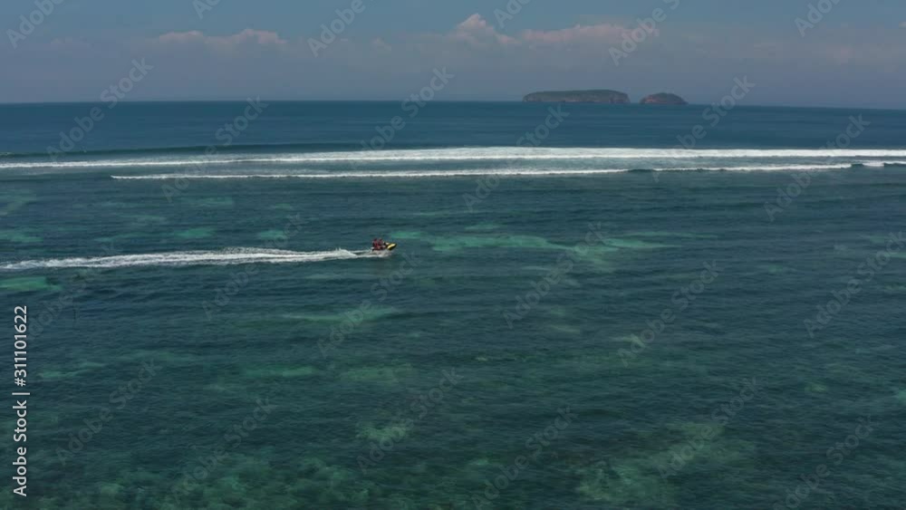 Top aerial view of jet ski racing on a crystal clear water. Extreme enjoying summer vacation. People are playing a water scooter in open sea waters. Watercraft adventure fresh day in summer holiday. Top aerial view of jet ski racing on a crystal clear water. Extreme enjoying summer vacation. People are playing a water scooter in open sea waters. Watercraft adventure fresh day in summer holiday.