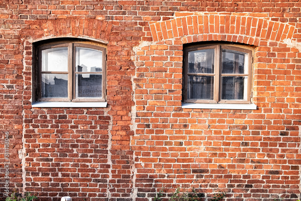 Fototapeta premium Old red brick wall with windows.