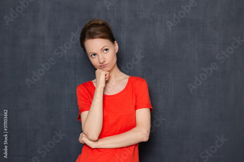 Portrait of dissatisfied woman being focused on unpleasant thoughts