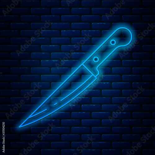 Glowing neon line Knife icon isolated on brick wall background. Cutlery symbol. Vector Illustration