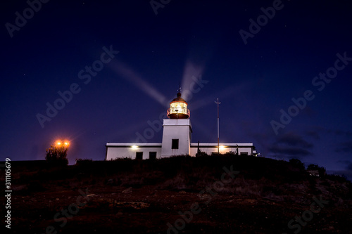 Ponta da Pargo lighthouse (also: Farol) in Portuguese island Madeira  Beacon in  Ponta da Vigia that stands on a cliff 300 metres above sea level giving light to the ocean, lamp light like stars.