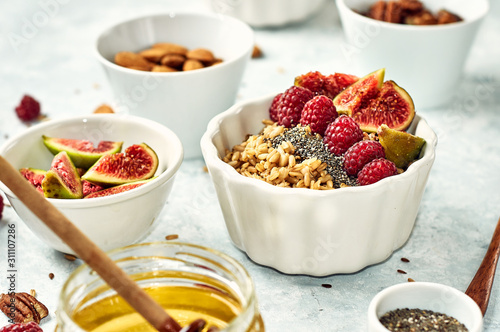 Oatmeal porridge with raspberry and figs in a bowl