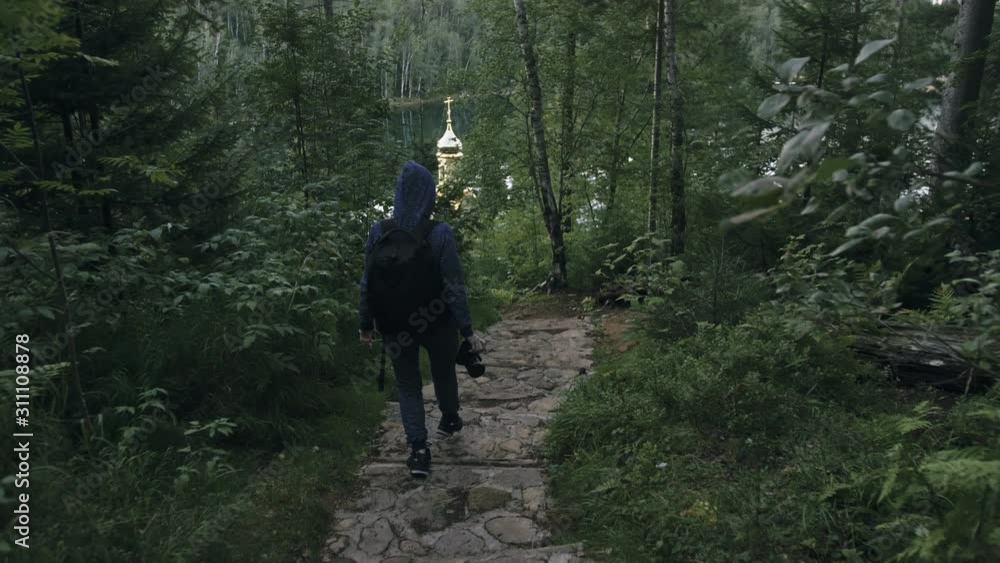 Traveler photographing scenic view in forest. One caucasian woman shooting nice magic look. Girl take photo video on dslr mirrorless camera. Professional photographer travel with backpack. Outdoor. Traveler photographing scenic view in forest. One caucasian woman shooting nice magic look. Girl take photo video on dslr mirrorless camera. Professional photographer travel with backpack. Outdoor.