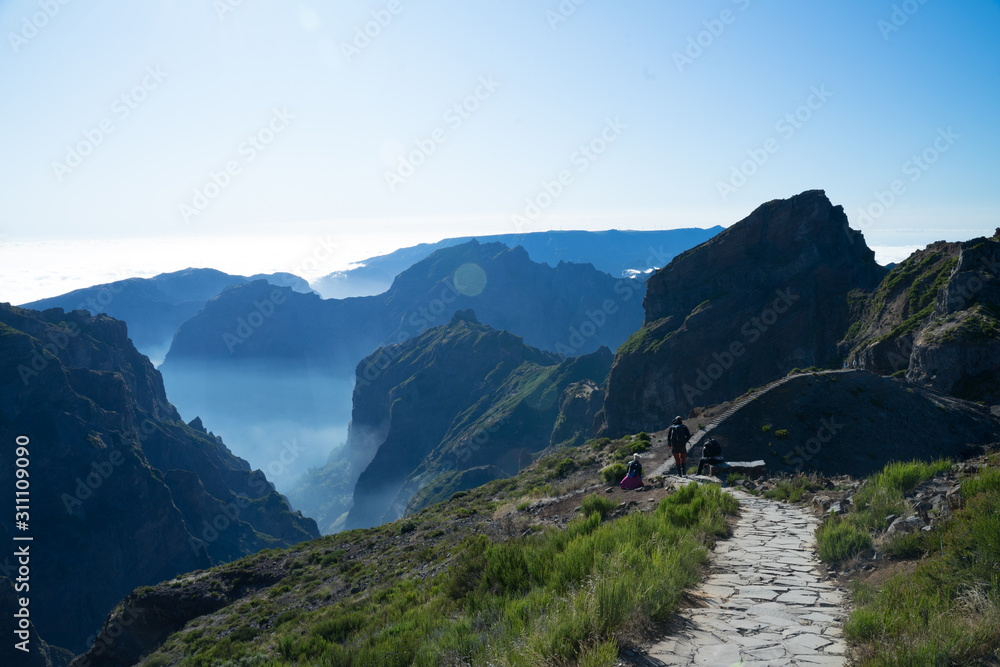 Path in picturesque mountainous landscape in Portuguese island Madeira on route to highest peaks between Pico Ruivo and Achada do Teixeira. Sunset time in mountains.
