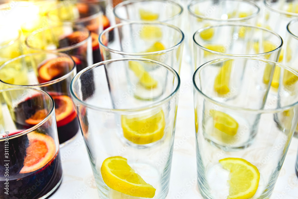 Empty glasses of liquor with lemon pieces sorterend by the bartender. Empty glasses of liquor with lemon pieces sorterend by the bartender.