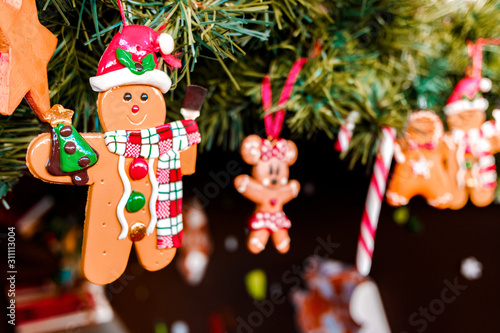 Dolls to decorate at Christmas hanging from the childlike tree.