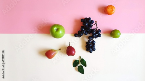 Fresh Eco Fruits Assortment  orange apelsin lilac grape yellow  pear mandarin and green apple blue plate healthy fitness food diet  pink modern abstract concept background diet wishes quotes text  photo