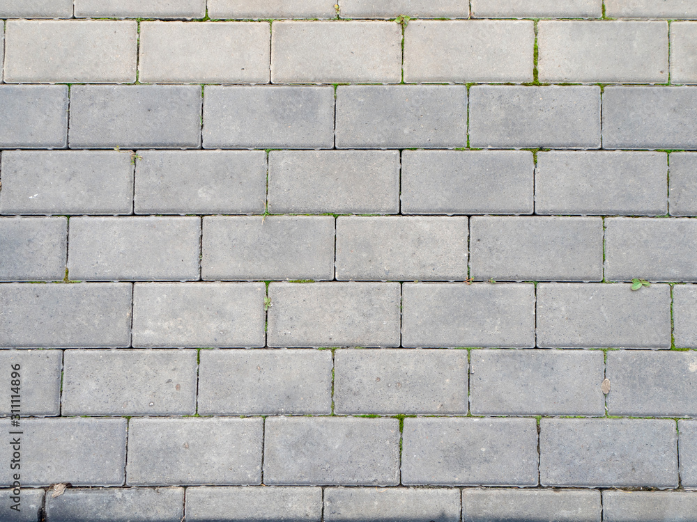 texture of gray rectangular pavers with grass between the seams texture of gray rectangular pavers with grass between the seams