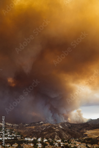 Vertical shot of California wildfire threatening a residential area