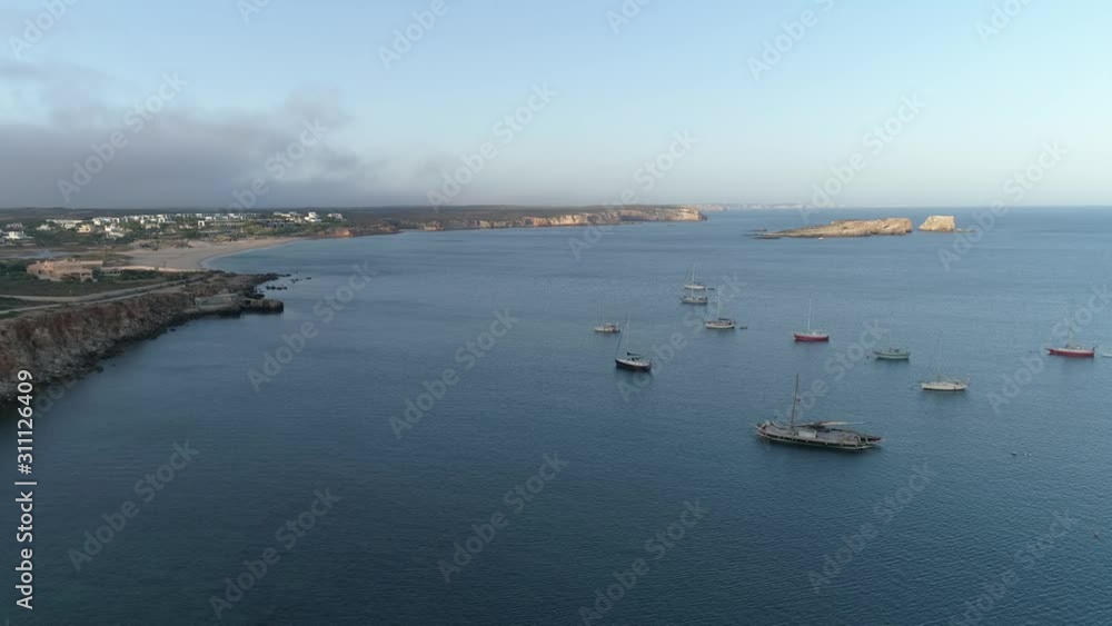 Aerial drone shot of fishing boats sail boats in the ocean off the coast of Portugal Aerial drone shot of fishing boats sail boats in the ocean off the coast of Portugal