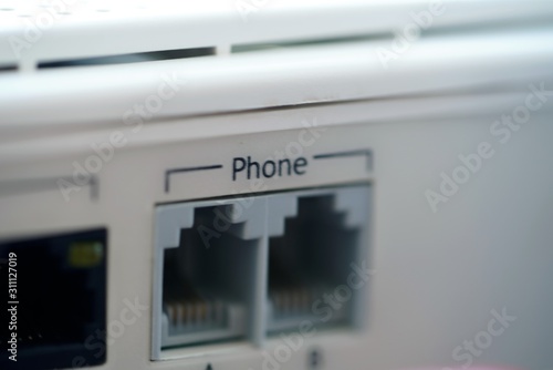 closeup of two phone ports on plastic panel of network router photo