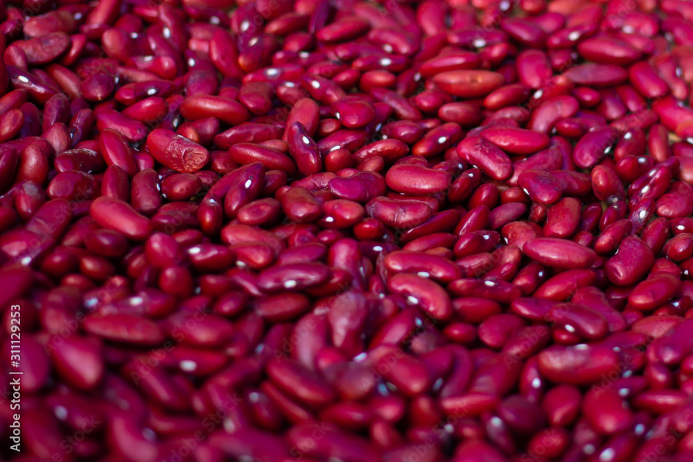Dark red dry azuki beans as the background on the wooden texture plate. Dark red dry azuki beans as the background on the wooden texture plate.