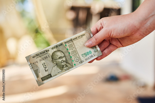A Girl holds a new Indian 500 rupee banknote. Indian rupees. photo