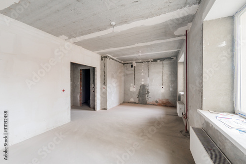 Russia, Omsk- August 05, 2019: interior room apartment. standard repair decoration in hostel. rough repair for self-finishing. interior decoration, bare walls of the room, stage of construction