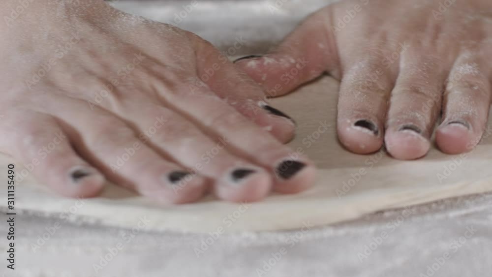 Professional baker is forming pieces of dough for baking pizza. Close up of raw bread. Bakery commercial kitchen Professional baker is forming pieces of dough for baking pizza. Close up of raw bread. Bakery commercial kitchen