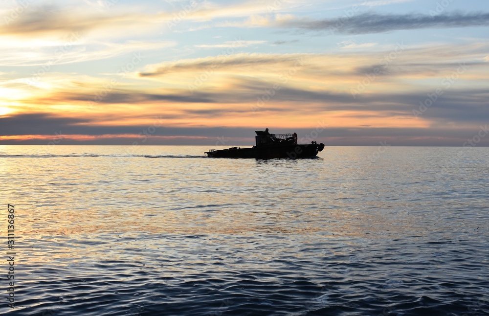 Boat in sea at sunset. Black Sea. Evening, colorful marine landscape. Boat in sea at sunset. Black Sea. Evening, colorful marine landscape.