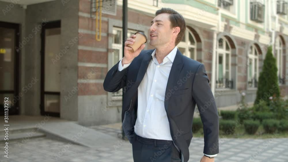 Closeup man going to work with coffee outdoor. Man going to job with coffee Closeup man going to work with coffee outdoor. Man going to job with coffee