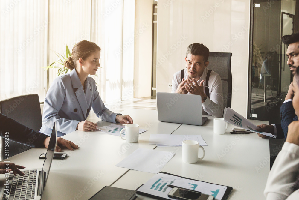 A team of young businessmen working and communicating together in an office. Corporate businessteam and manager in a meeting A team of young businessmen working and communicating together in an office. Corporate businessteam and manager in a meeting