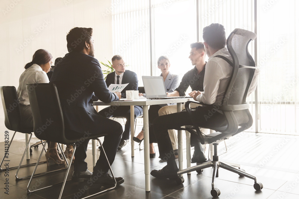 Silhouettes of people sitting at the table. A team of young businessmen working and communicating together in an office. Corporate businessteam and manager in a meeting Silhouettes of people sitting at the table. A team of young businessmen working and communicating together in an office. Corporate businessteam and manager in a meeting