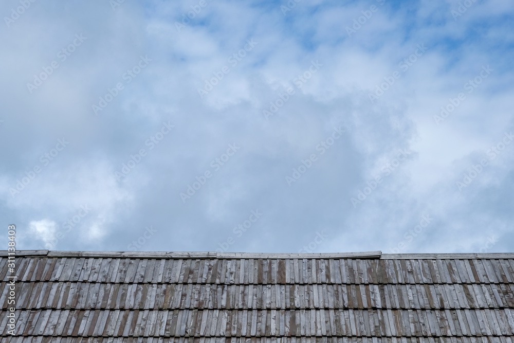 Wooden roof with cloudy sky in background. Wooden roof with cloudy sky in background.