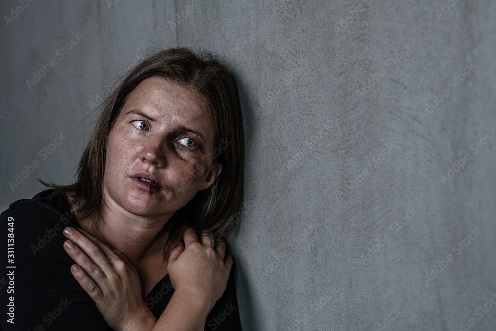 Portrait of the woman victim of domestic violence and abuse looks on empty space. Empty space for text Portrait of the woman victim of domestic violence and abuse looks on empty space. Empty space for text