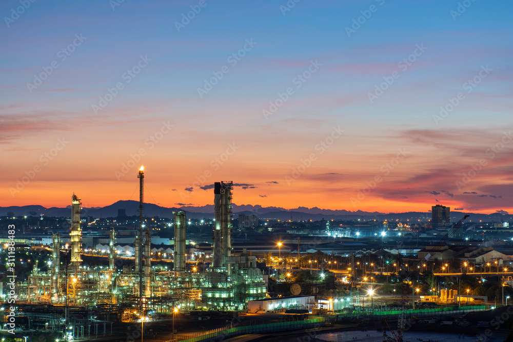 Oil refinery and petrochemical plants, natural gas storage tanks, industrial city at sunrise