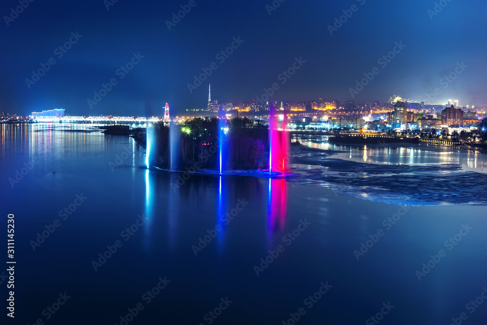 Night fountains on the Yenisei River overlooking the night Siberian city of Krasnoyarsk 03.02.2019