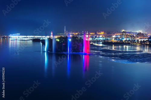 Night fountains on the Yenisei River overlooking the night Siberian city of Krasnoyarsk 03.02.2019