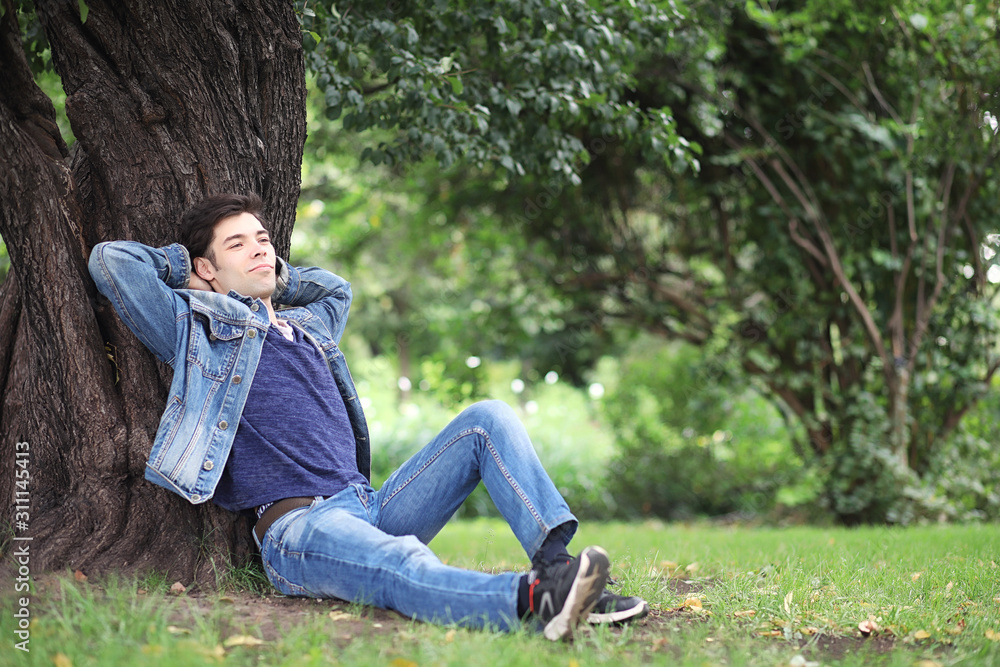 A young man walks in the park at lunch time. A man is on a walk in the city. A student in the park. A young man walks in the park at lunch time. A man is on a walk in the city. A student in the park.