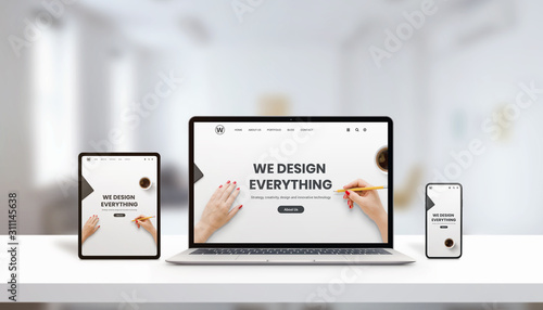 Responsive agency web page on laptop, tablet and phone display concept. Modern, flat web page design. Modern devices with thin edges. Office, studio desk