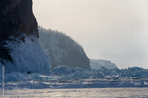 winter landscape with frozen lake Baikal and mountains on the island of Olkhon