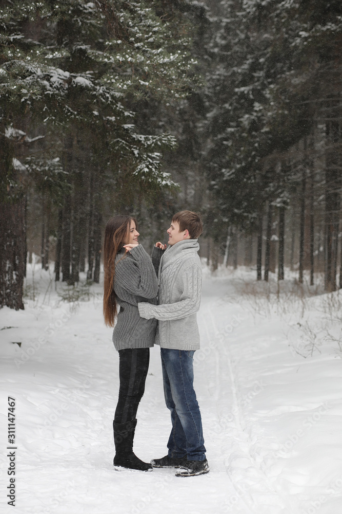 pair of lovers on a date winter afternoon in a snow blizzard