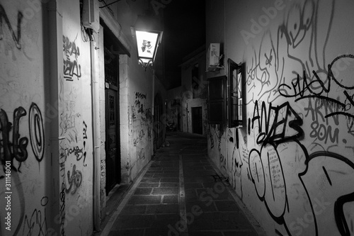 Fototapeta Naklejka Na Ścianę i Meble -  Walking in the night streets of Crete. Greece. Black and white