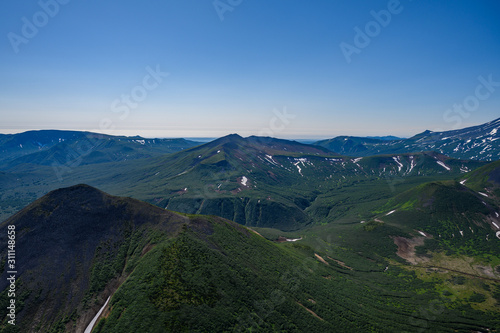 Panoramic view of the city Petropavlovsk-Kamchatsky and volcanoes: Koryaksky Volcano, Avacha Volcano, Kozelsky Volcano. Russian Far East, Kamchatka Peninsula.