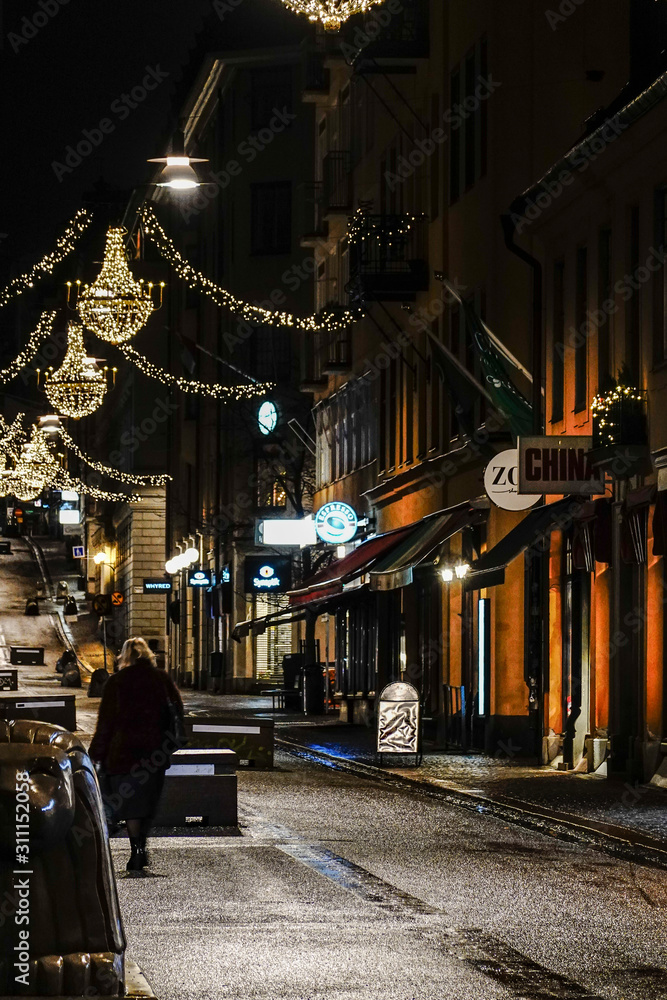 Stockholm, Sweden A lone pedestrian on Drottninggatan in the early morning at Christmas