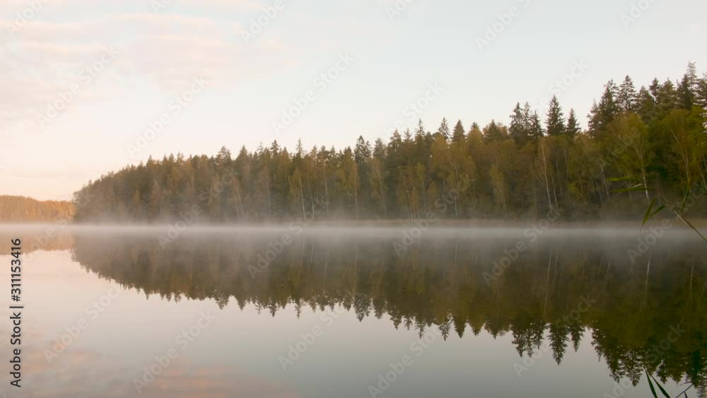 Morning fog over the lake next to the autumn forest Morning fog over the lake next to the autumn forest