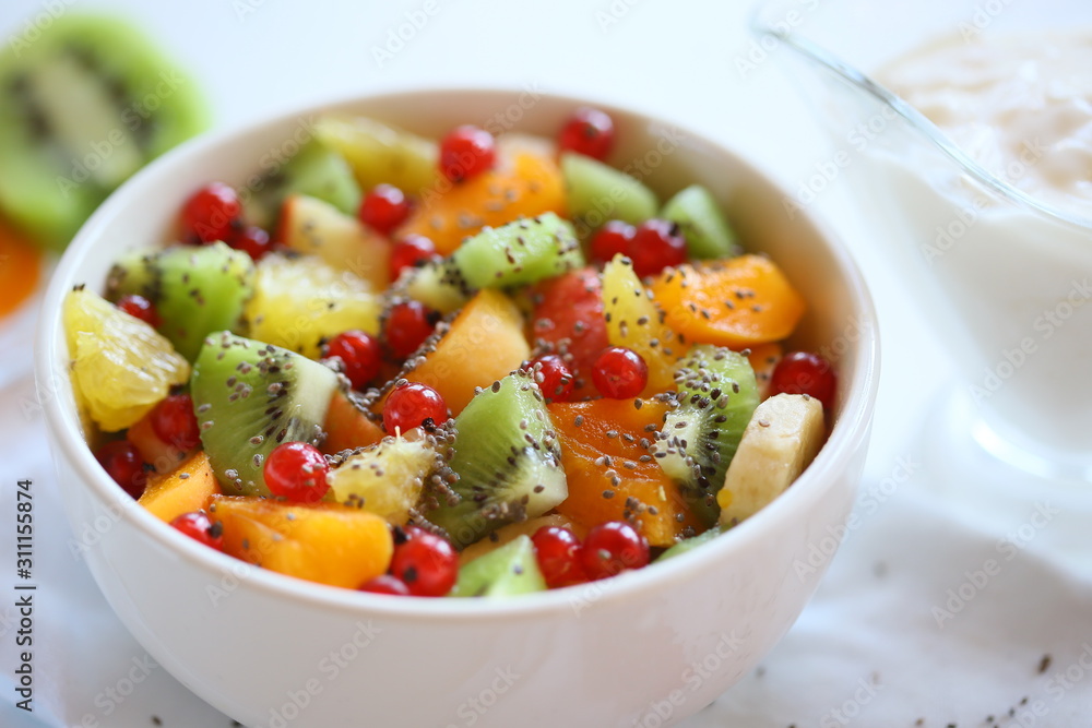 Healthy summer Breakfast concept, fruit salad in a white bowl. Vegetarian food concept. Weight loss concept. Healthy summer Breakfast concept, fruit salad in a white bowl. Vegetarian food concept. Weight loss concept.