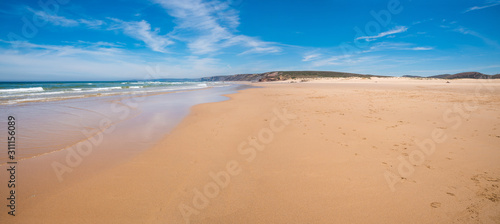 wide sandy beach Bordeira, west algarve portugal. without people. cliffs at the horizon