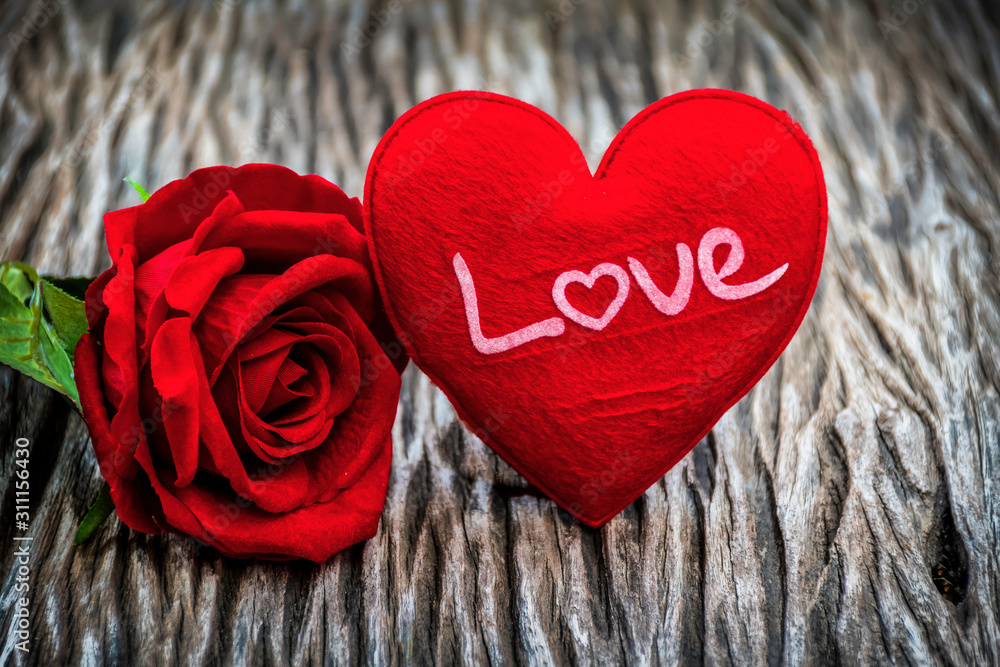Fototapeta premium red heart shape and red rose on wooden background, vintage style, love and valentine concept.