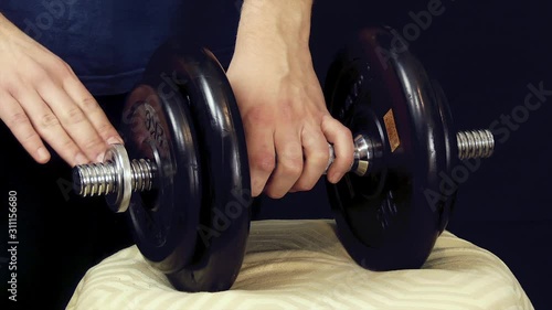 Man Unscrews Dumbbell to Change its Weight