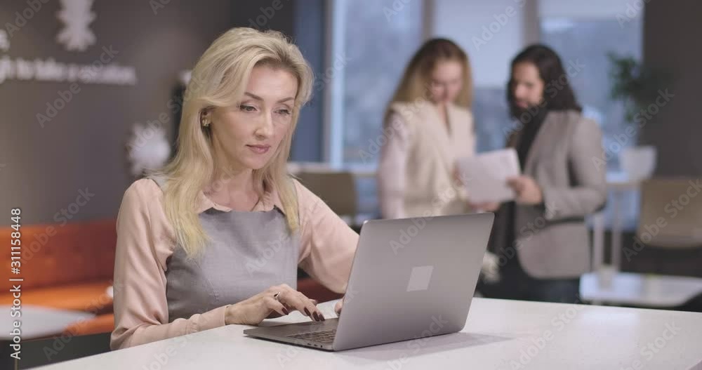 Portrait of young beautiful Caucasian woman typing on laptop keyboard. Portrait of confident successful CEO at workplace. Businesswoman, manager, efficiency, office, lifestyle. Cinema 4k ProRes HQ. Portrait of young beautiful Caucasian woman typing on laptop keyboard. Portrait of confident successful CEO at workplace. Businesswoman, manager, efficiency, office, lifestyle. Cinema 4k ProRes HQ.