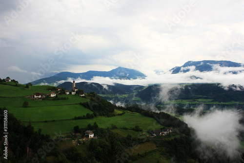 Slopes of the Dolomites in white clouds